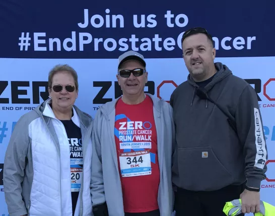 Three older man standing at a prostate cancer event 